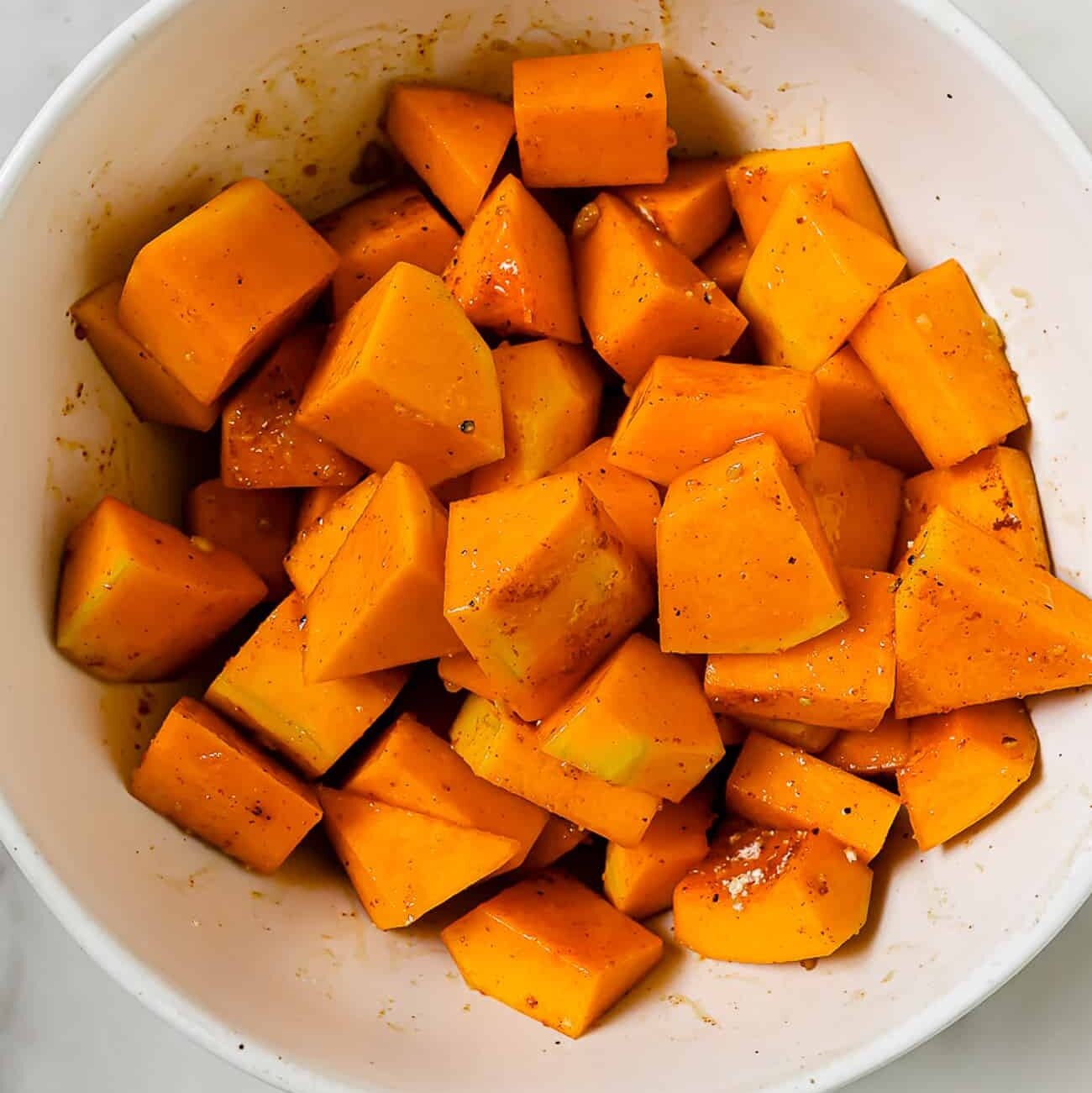 An overhead view of the squash coated in seasonings.