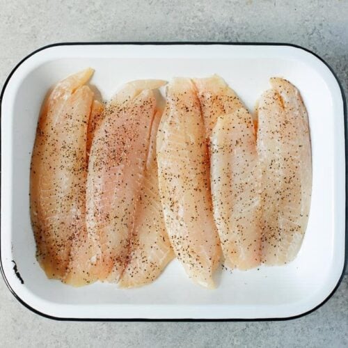 raw tilapia in a baking sheet