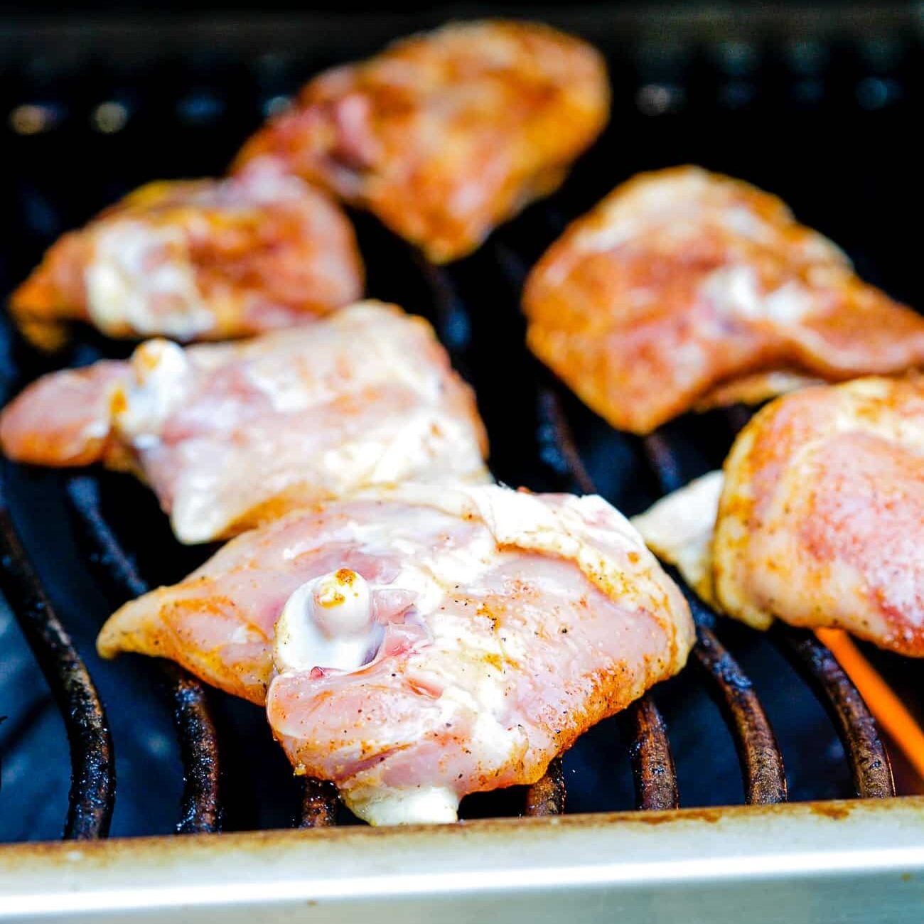 raw chicken thighs on the grill