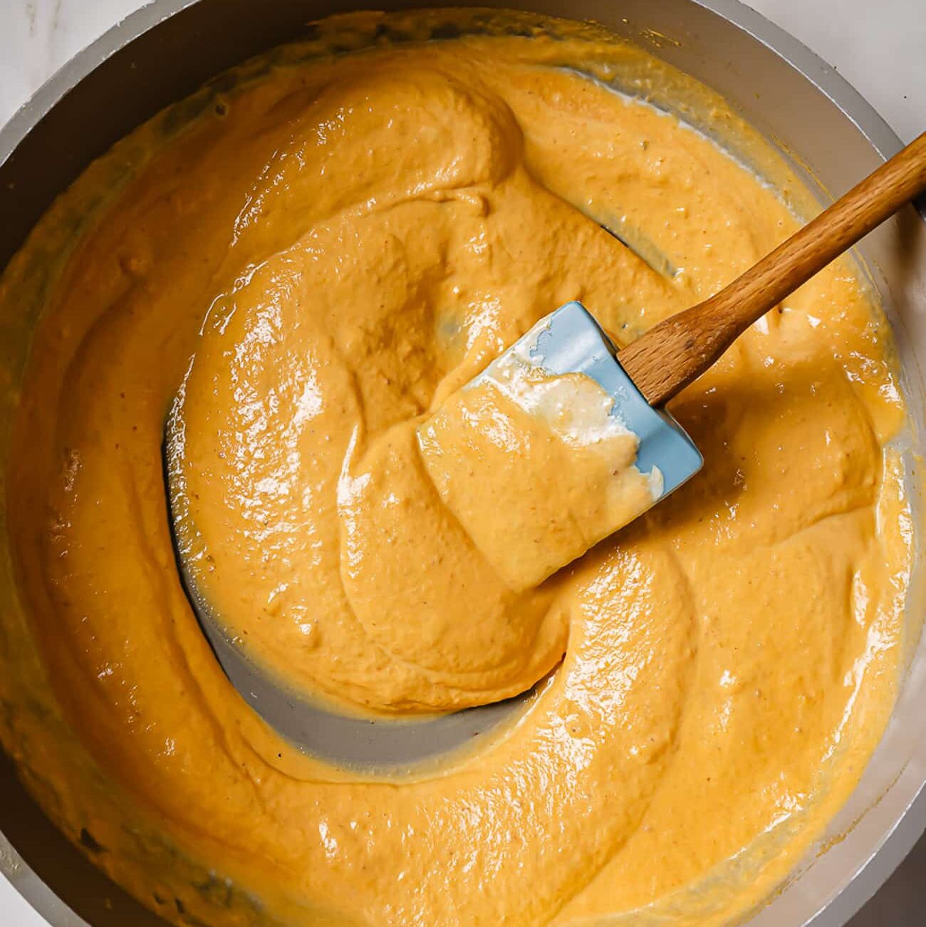 Pumpkin puree and heavy cream added to the skillet.
