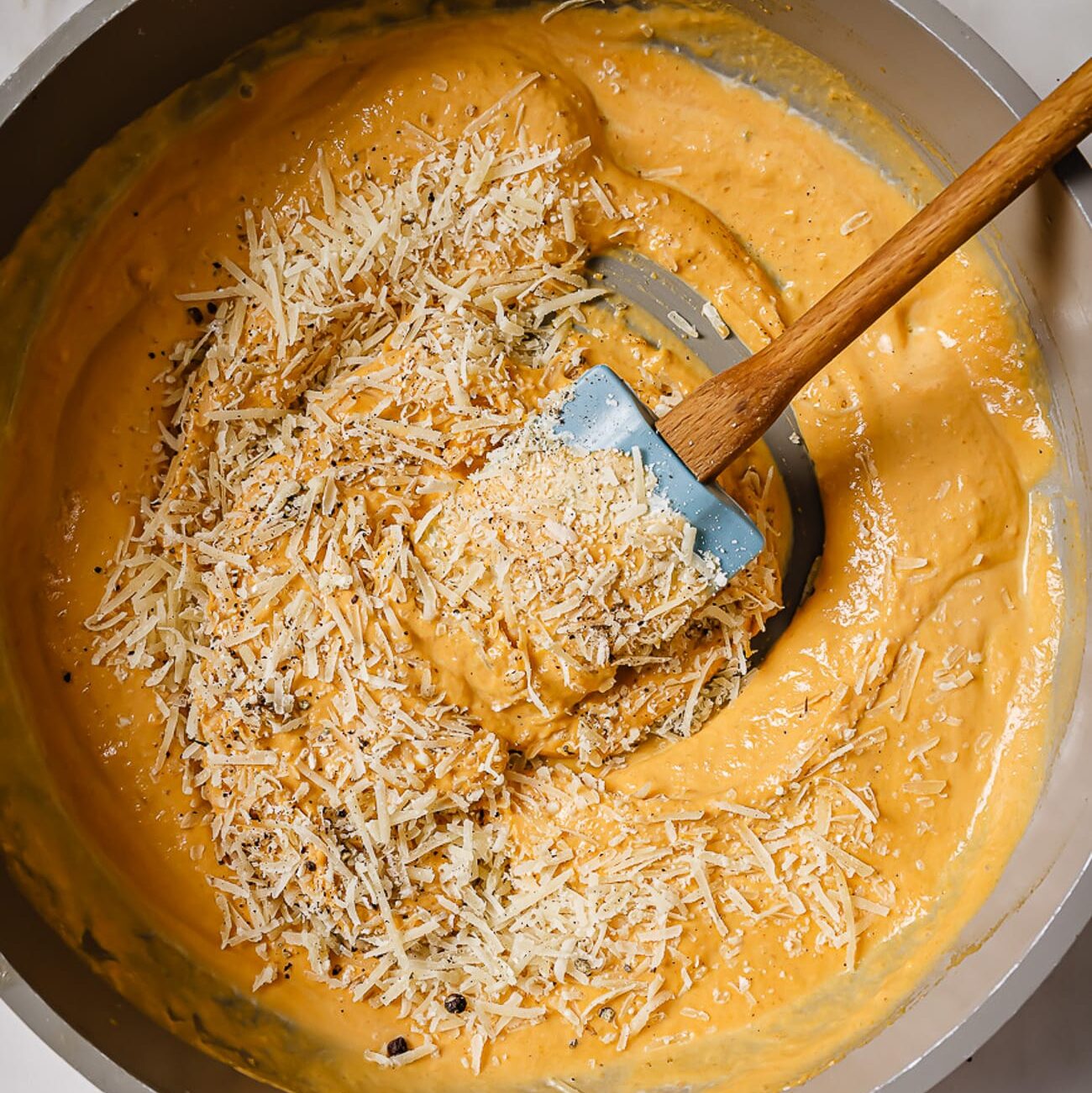 Parmesan cheese, salt, and pepper added to the skillet.
